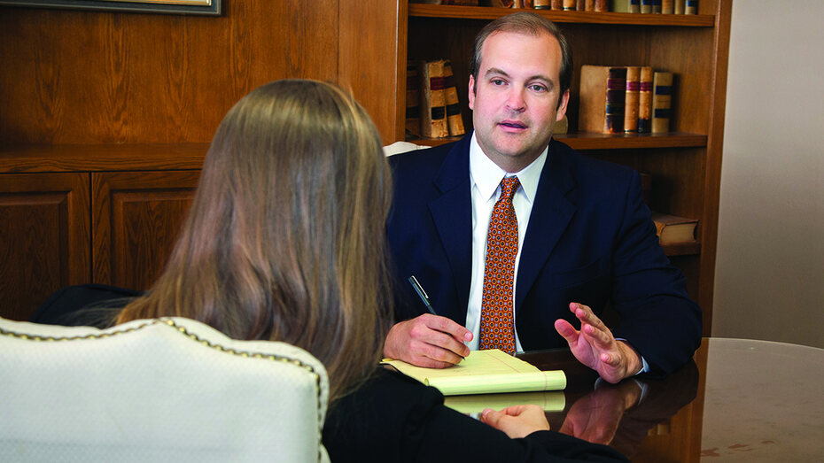 Brandon Martin meeting with a client at his office